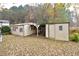 Image of two outbuildings with one shared roofline, on a leaf-strewn lot at 124 Jack Bennett Rd, Chapel Hill, NC 27517