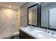 Updated bathroom with double sink vanity, modern fixtures, and a large walk-in shower with marble tile at 1344 Highland Dr, Wake Forest, NC 27587
