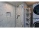 Bathroom features a glass enclosed shower with a built-in soap niche and stackable washer/dryer at 1344 Highland Dr, Wake Forest, NC 27587