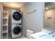 Bathroom with new stackable washer/dryer, new vanity and sink, and white toilet at 1344 Highland Dr, Wake Forest, NC 27587