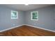 This bedroom features two windows and hardwood floors at 1344 Highland Dr, Wake Forest, NC 27587
