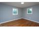 This bedroom features two windows and hardwood floors at 1344 Highland Dr, Wake Forest, NC 27587