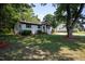 Well-maintained home exterior with a lush green lawn and mature trees, creating a serene and inviting atmosphere at 1344 Highland Dr, Wake Forest, NC 27587