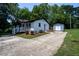 Quaint home with white exterior, driveway, and matching storage building at 1344 Highland Dr, Wake Forest, NC 27587