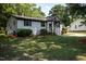 Charming home with white exterior, black trim, and well-maintained landscaping at 1344 Highland Dr, Wake Forest, NC 27587