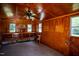 Storage building interior featuring wood paneling, multiple windows, and shelving at 1344 Highland Dr, Wake Forest, NC 27587