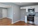 Beautifully renovated kitchen with stainless steel appliances, granite countertops, and hardwood floors at 1344 Highland Dr, Wake Forest, NC 27587
