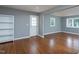 Cozy living room featuring hardwood floors, neutral paint, and ample natural light with open doorway to a second room at 1344 Highland Dr, Wake Forest, NC 27587