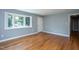 Bright living room features a bay window, hardwood floors, fresh paint, and a white front door at 1344 Highland Dr, Wake Forest, NC 27587