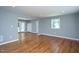 Spacious living room with hardwood floors, neutral paint, plenty of natural light and an open doorway at 1344 Highland Dr, Wake Forest, NC 27587