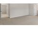 Bedroom offers neutral carpeting and two open doorways to other rooms at 136 Global Ave, Fuquay Varina, NC 27526
