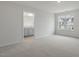 Bedroom features neutral carpeting, a window, and an ensuite bathroom at 136 Global Ave, Fuquay Varina, NC 27526