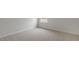Neutral bedroom with window and plush carpeting at 136 Global Ave, Fuquay Varina, NC 27526