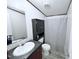 Compact bathroom with a vanity, toilet, and shower with a patterned curtain at 1404 N N Nc Hwy 87, Elon, NC 27244