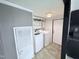 Convenient laundry area with modern washer and dryer units, and custom shelving at 1404 N N Nc Hwy 87, Elon, NC 27244