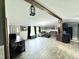 Open-concept living area with vinyl floors, seamlessly connecting the kitchen and living room spaces at 1404 N N Nc Hwy 87, Elon, NC 27244