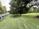 Large yard with mature trees and a well-maintained lawn at 1404 N N Nc Hwy 87, Elon, NC 27244
