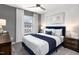 Bright bedroom featuring a large window, plush carpet, and a modern ceiling fan, emphasizing comfort and style at 1516 Tamarisk Ln, Durham, NC 27703