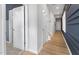 Spacious hallway with modern wood flooring and crisp white walls, highlighting the home's contemporary design at 1516 Tamarisk Ln, Durham, NC 27703