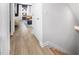 Bright hallway with light wood flooring leading to a living space, showcasing natural light and open design at 1516 Tamarisk Ln, Durham, NC 27703