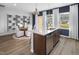 Open-concept kitchen with stainless steel appliances, a granite island, and adjacent dining area, perfect for entertaining at 1516 Tamarisk Ln, Durham, NC 27703