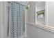 Shower space in basement bathroom, complemented by a built-in shelf and clean, white fixtures at 1600 Pineview St, Raleigh, NC 27608