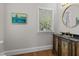 Powder room showcasing an antique vanity with a round mirror and natural light at 1600 Pineview St, Raleigh, NC 27608