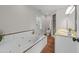 Spacious bathroom featuring a large jacuzzi tub, a walk-in shower, and dual sinks at 1600 Pineview St, Raleigh, NC 27608