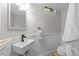 Modern basement bathroom with a floating sink, wainscotting and a clean, functional design at 1600 Pineview St, Raleigh, NC 27608