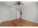 Bedroom featuring hardwood floors, tray ceilings, white trim, and closet storage space at 1600 Pineview St, Raleigh, NC 27608