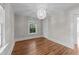 Bedroom with hardwood floors, a modern light fixture and a window allowing natural light at 1600 Pineview St, Raleigh, NC 27608