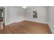 Bright bedroom with hardwood floors, a window, white trim and a simple overhead light fixture at 1600 Pineview St, Raleigh, NC 27608