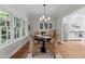 Sun-filled dining area featuring windows, chandelier, and an open design adjoining the kitchen, perfect for entertaining at 1600 Pineview St, Raleigh, NC 27608