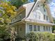 Charming home exterior featuring unique architecture, lush landscaping, and plenty of natural light from numerous windows at 1600 Pineview St, Raleigh, NC 27608