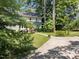 Lushly landscaped home exterior with a long driveway and inviting curb appeal at 1600 Pineview St, Raleigh, NC 27608