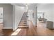 Bright foyer with hardwood floors, staircase, and views of the living room, providing a welcoming entrance to the home at 1600 Pineview St, Raleigh, NC 27608