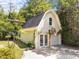 Detached garage featuring a basketball hoop and double doors at 1600 Pineview St, Raleigh, NC 27608