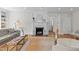 Comfortable living room with a decorative fireplace, built-in shelving, and a neutral color palette for relaxation at 1600 Pineview St, Raleigh, NC 27608