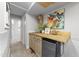 Basement wet bar featuring wood countertops, a mini-fridge, and artistic decor on display at 1600 Pineview St, Raleigh, NC 27608