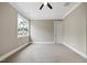 This carpeted bedroom has a ceiling fan, a window, and a white door at 1600 Sweetwater Ln, Raleigh, NC 27610