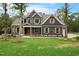 Charming home with craftsman details, yellow flowers, and a lush green lawn at 1600 Sweetwater Ln, Raleigh, NC 27610