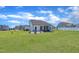 A well-manicured backyard features a screened porch and a fire pit with chairs at 175 Steep Rock Dr, Willow Springs, NC 27592