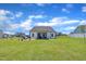 Spacious backyard showing the outdoor firepit, screened in porch and white fencing at 175 Steep Rock Dr, Willow Springs, NC 27592