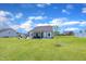 Expansive backyard with an outdoor firepit, small tree, and a screened-in porch at 175 Steep Rock Dr, Willow Springs, NC 27592