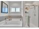 Bathroom featuring a tub and a tiled shower with a glass enclosure at 175 Steep Rock Dr, Willow Springs, NC 27592