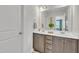 Bathroom featuring double sinks, stylish vanity, and a mirror, offering both functionality and aesthetic appeal at 175 Steep Rock Dr, Willow Springs, NC 27592