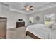 Carpeted bedroom featuring a ceiling fan, and a dark wood dresser and bedframe at 175 Steep Rock Dr, Willow Springs, NC 27592