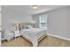 Neutral bedroom featuring a window and upholstered headboard at 175 Steep Rock Dr, Willow Springs, NC 27592