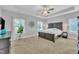 Spacious bedroom featuring a trey ceiling, neutral walls, and a dark wood, carved bedframe at 175 Steep Rock Dr, Willow Springs, NC 27592