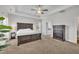 Carpeted bedroom featuring a ceiling fan, and a dark wood dresser and bedframe at 175 Steep Rock Dr, Willow Springs, NC 27592